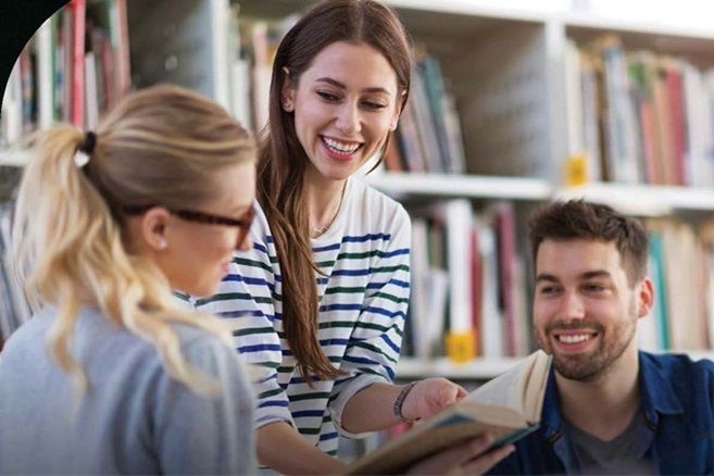 Female students reading in notebook