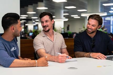 ECC post-graduate qualifying program students collaborating and discussing coursework