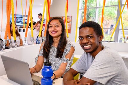 Female and male on laptop