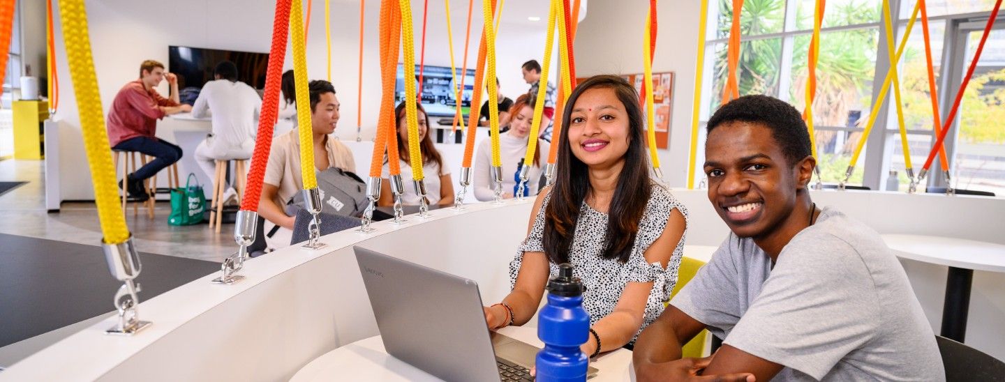 Female and male on laptop
