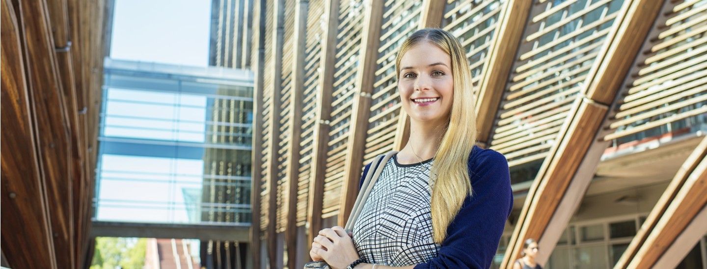 Female standing front of building