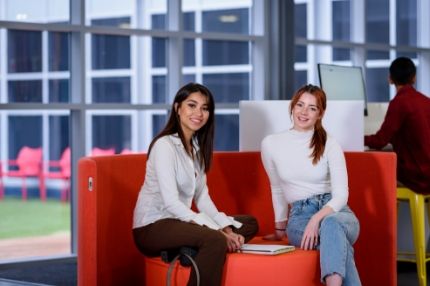 Female students sitting in booth