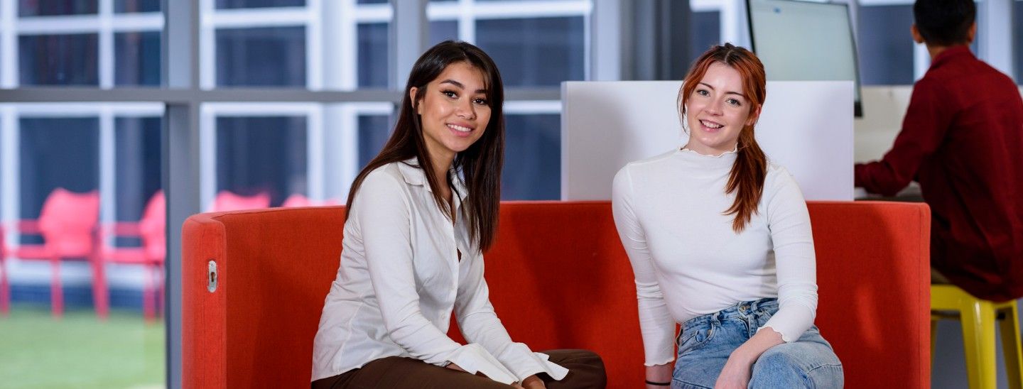 Female students sitting in booth