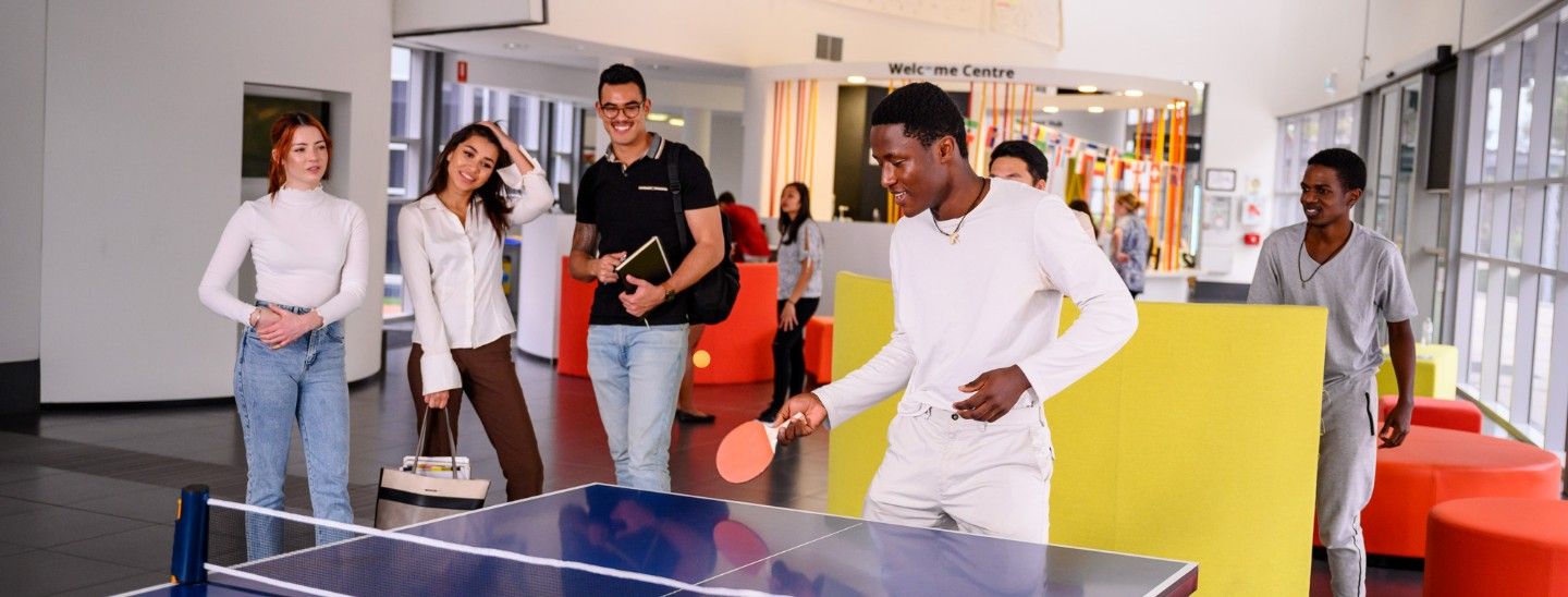 Group playing table tennis