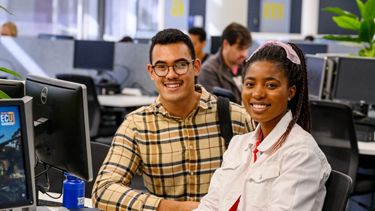 Male and female in computer room