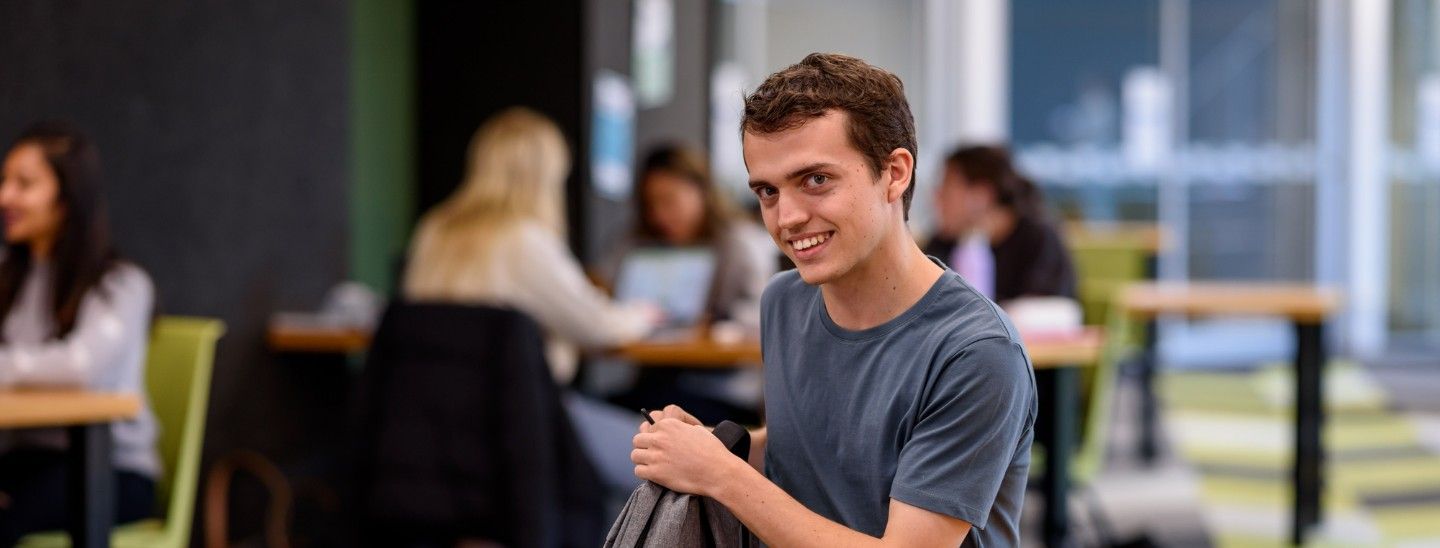 Male sitting and holding bag