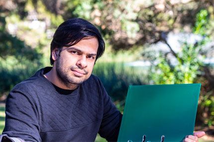 Male sitting holding folder