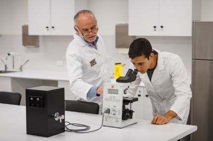 Male student and teacher testing in lab