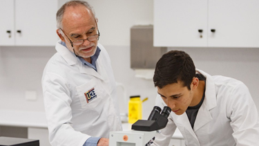 Male student and teacher testing in lab