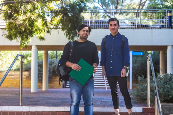 Male students walking down stairs