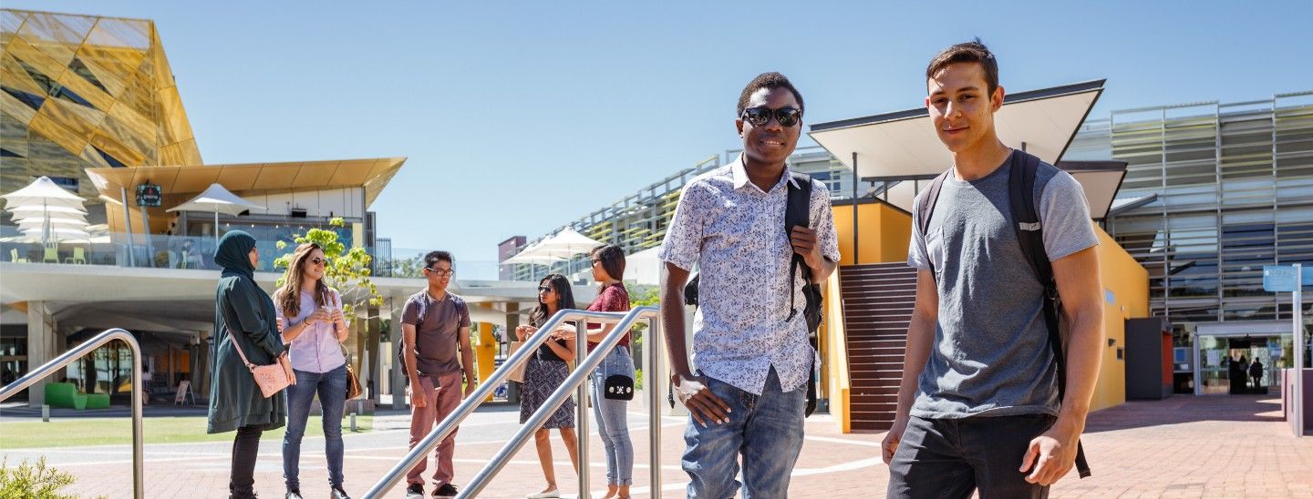 Male students walking down stairs