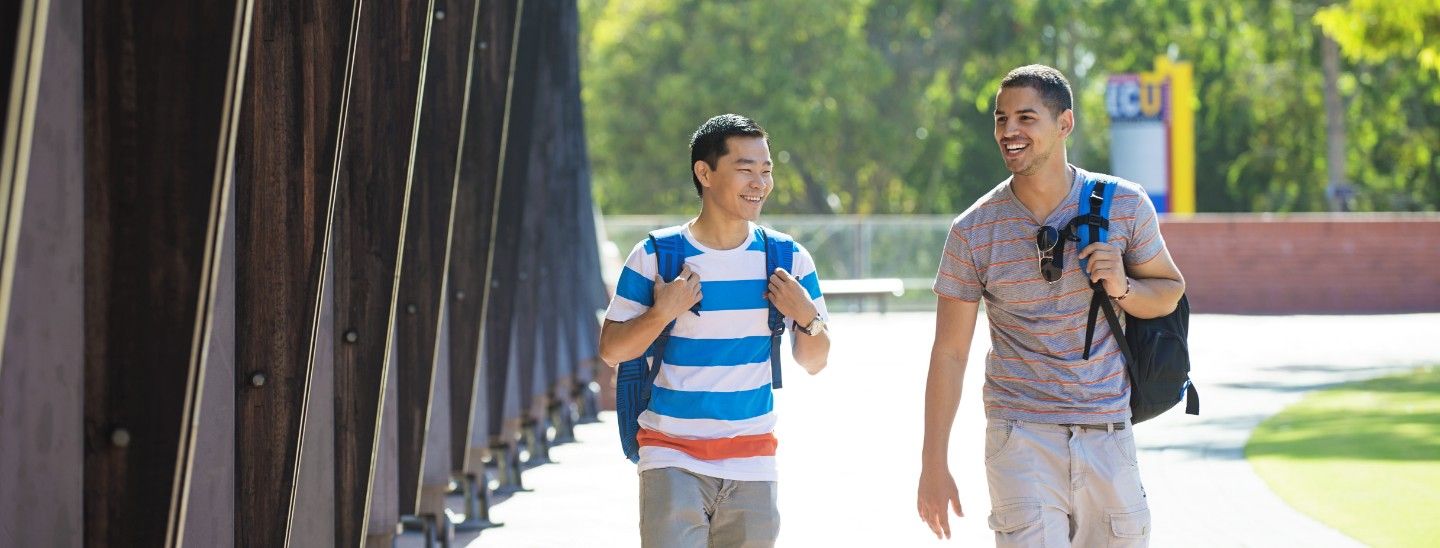 Male students walking outside