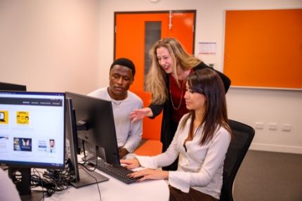 Teacher helping students