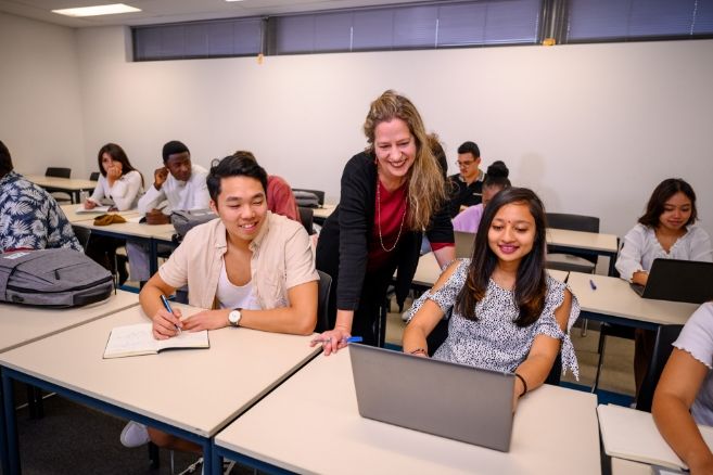 Teacher helping students