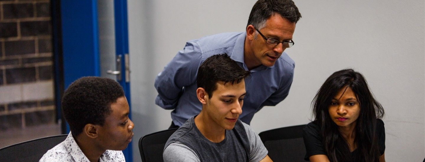 Campus teacher helping students