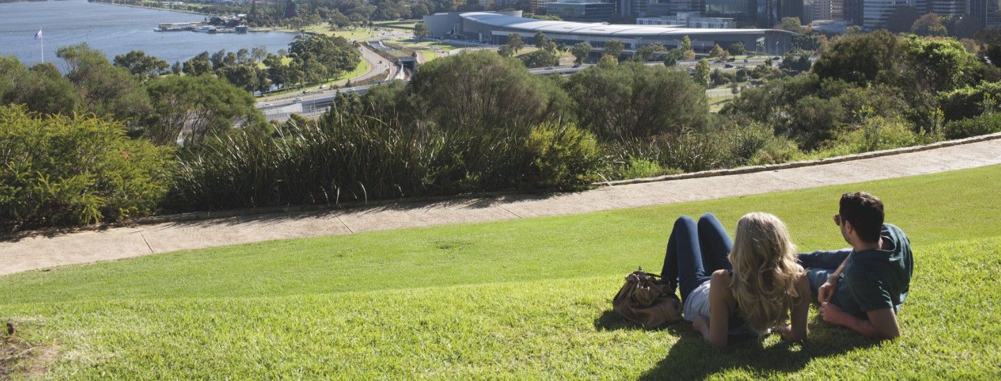Off campus female and male looking at city view