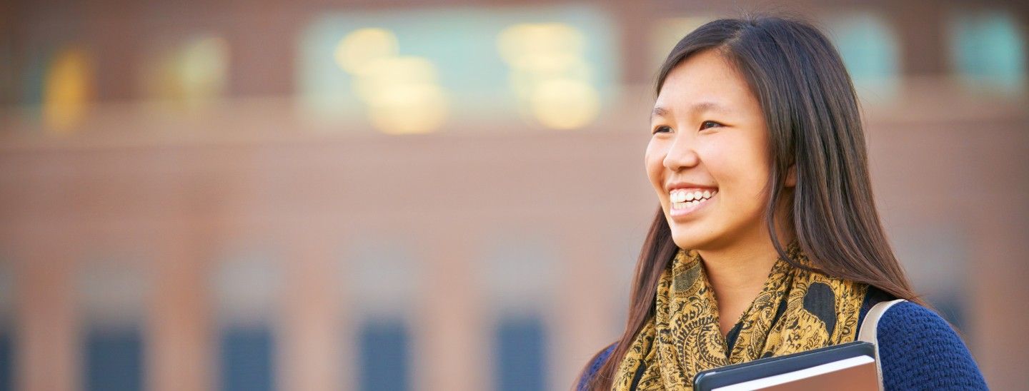 Off campus female holding books