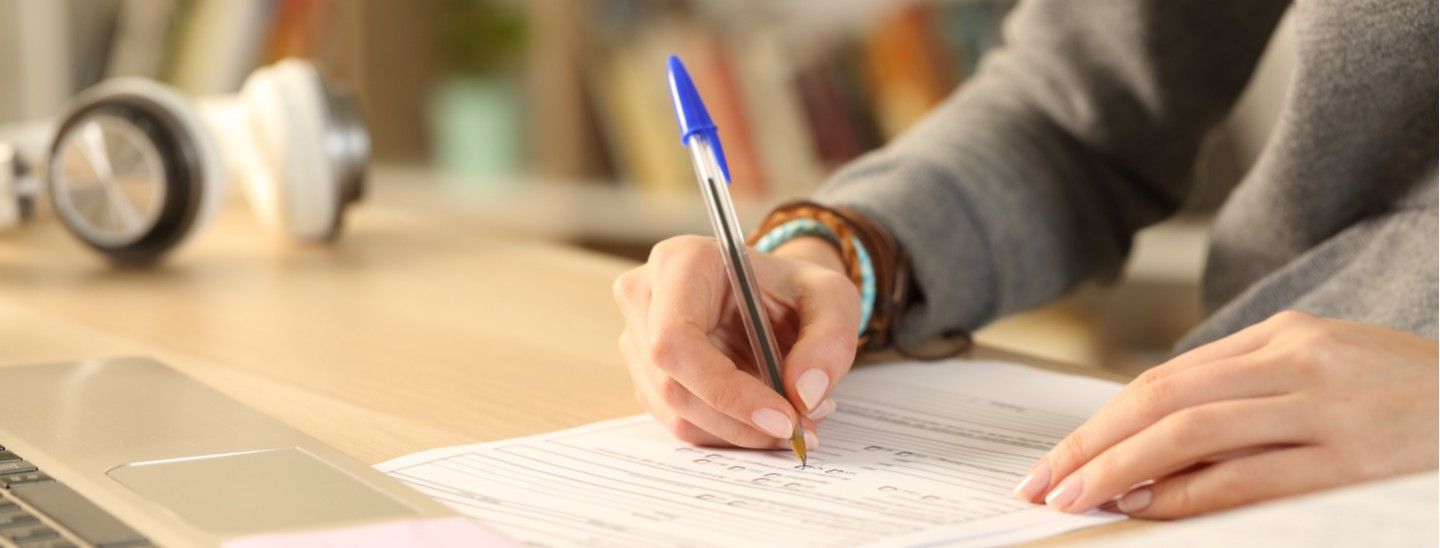 Off campus female writting on form