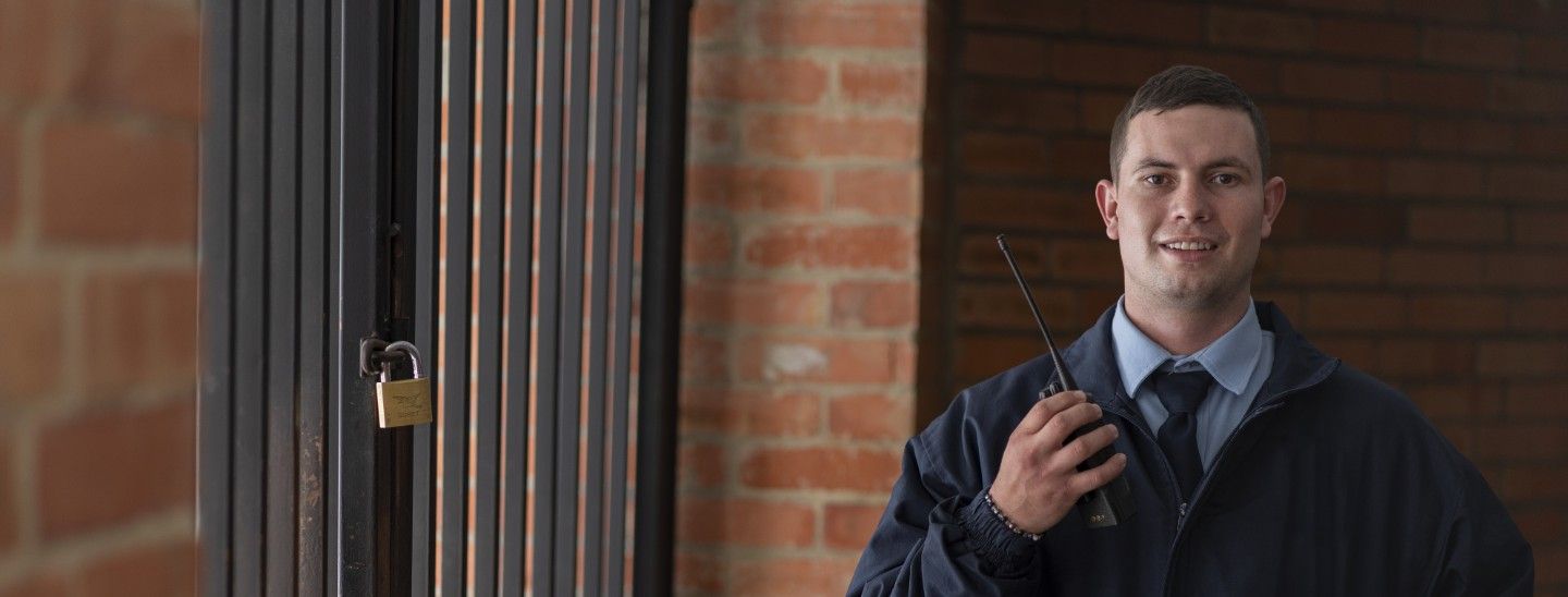 Off campus male security guard standing