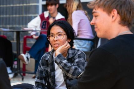 A group of students engaged in an outdoor conversation