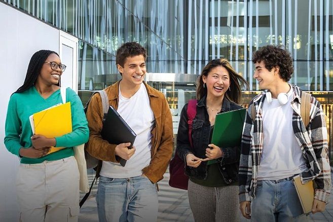 Students group holding files and laughing