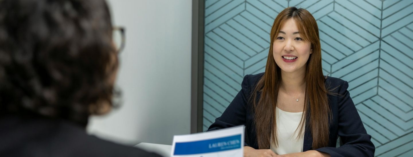 Female student smiling during a job interview with a recruiter.