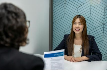 Female student smiling during a job interview with a recruiter.