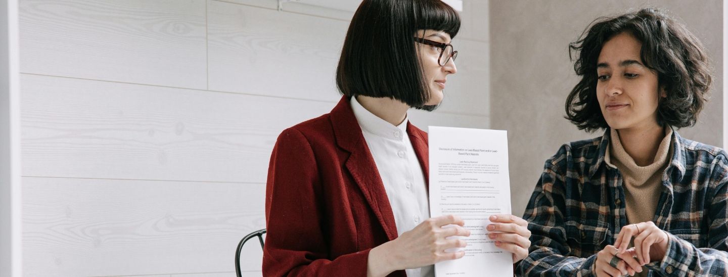 A legal consultant providing professional advice and reviewing contract terms with a client.
